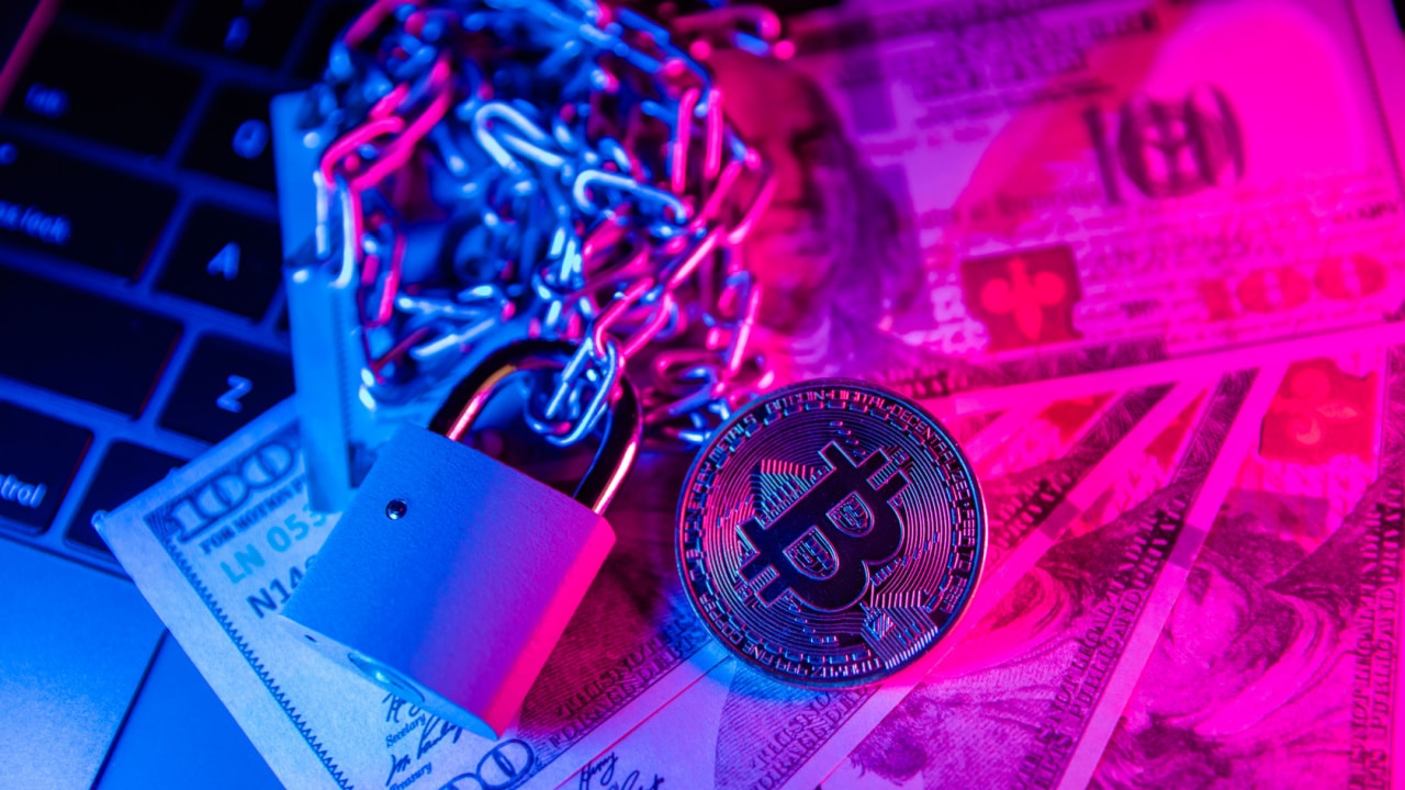 Image showing a bitcoin token secured with a chain and closed padlock