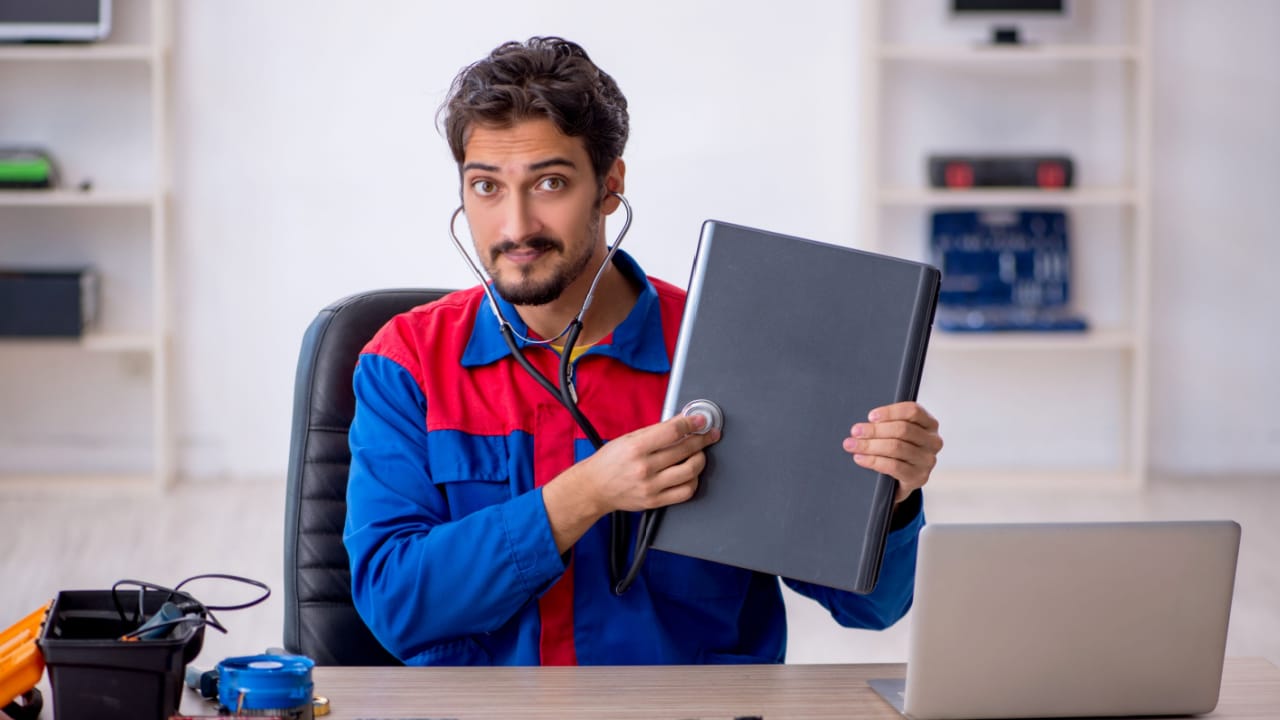 repairman refurbishing a laptop