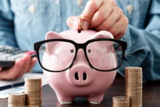 Piggy bank saving money wearing sunglasses