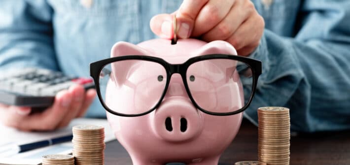 Piggy bank saving money wearing sunglasses