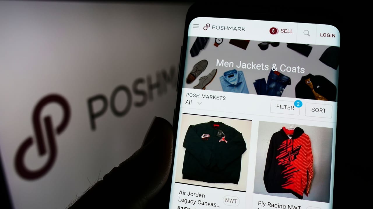Person holding cellphone with webpage of US social marketplace company Poshmark Inc.