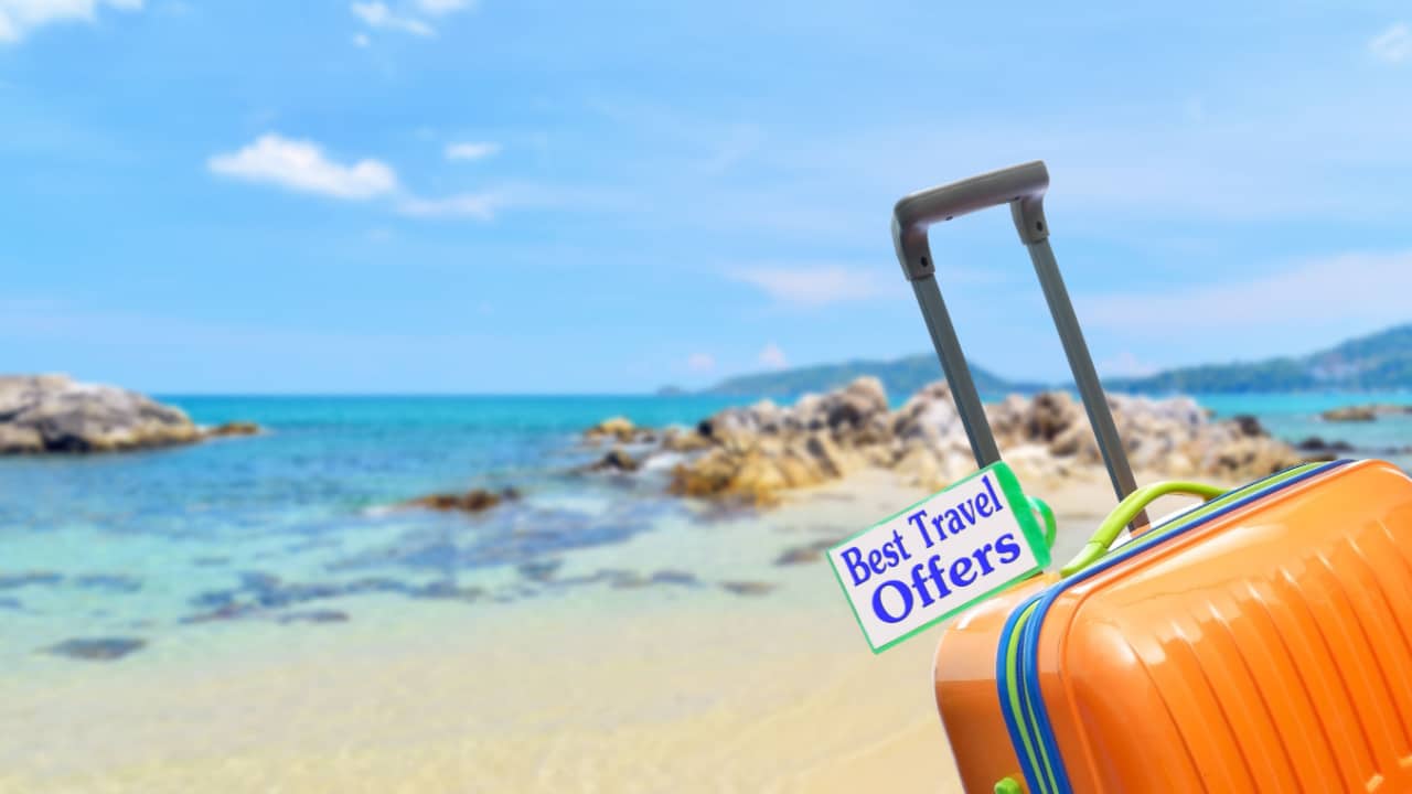 image of the sea with a suitcase and a label that says best travel offers