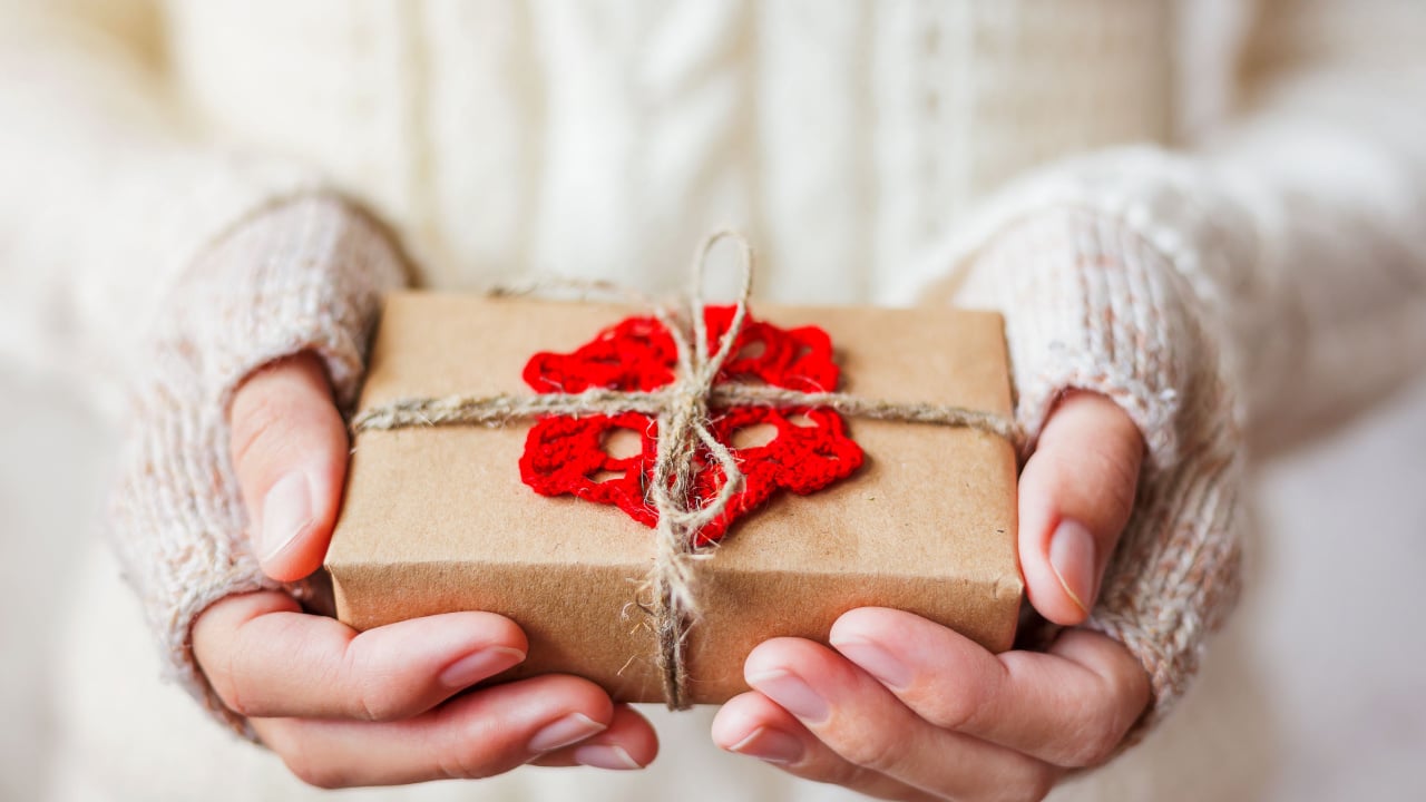 Woman in jumper holding handmade gift