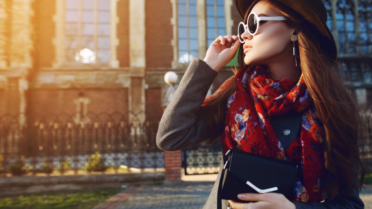 Woman dressed up in sunglasses and scarf, fashionista