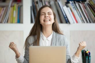 Woman cheers at succeeding with her personal goals set for her future