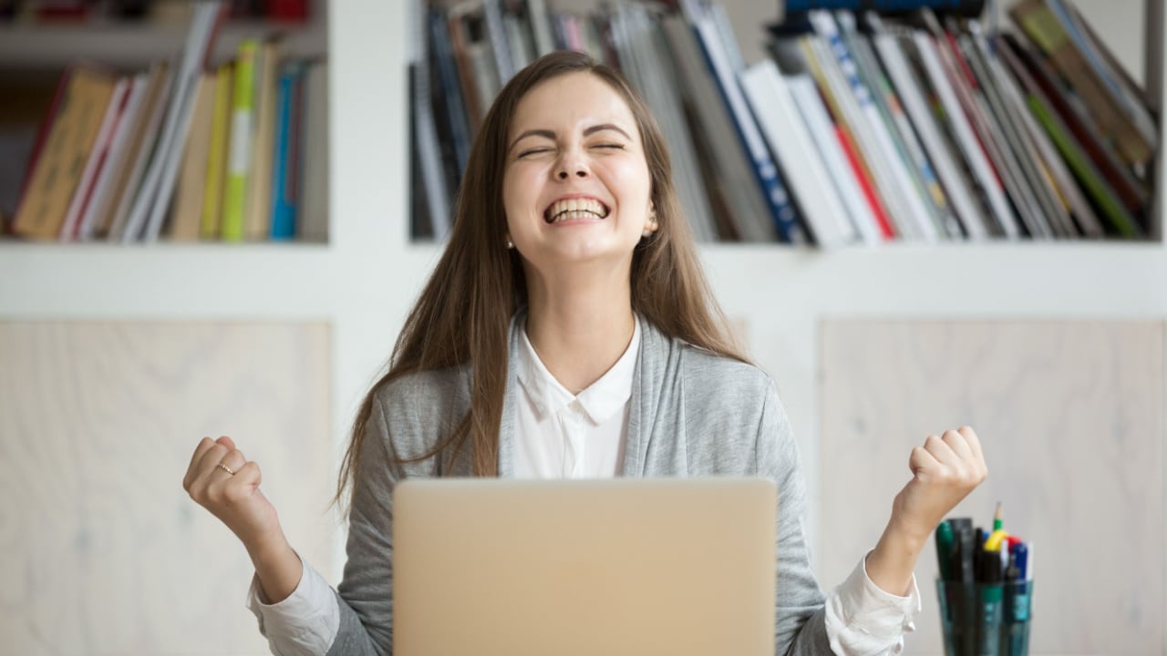 Woman cheers at succeeding with her personal goals set for her future