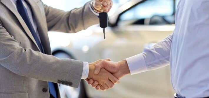 car keys shaking hands salesman