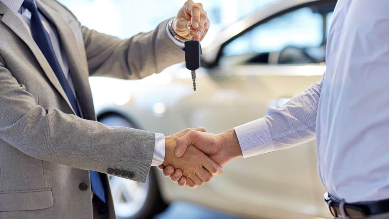 car keys shaking hands salesman