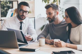 40 year old couple working with financial advisor on investments